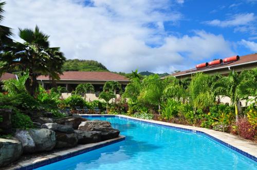 a swimming pool in front of a resort at Sunset Resort in Rarotonga