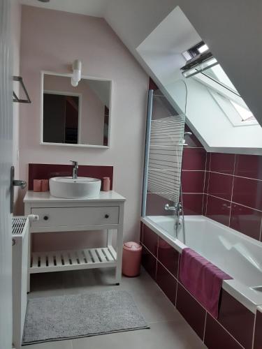 a bathroom with a sink and a tub and a mirror at Kerlann Bruz in Bruz