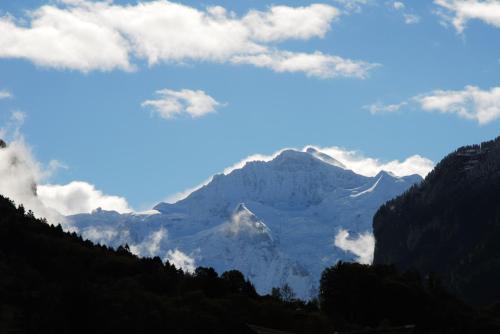 einen Blick auf eine Bergkette mit Wolken im Himmel in der Unterkunft Ferienwohnung Interlaken/Wilderswil in Wilderswil