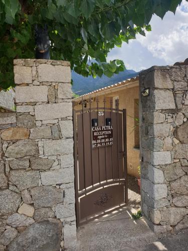 d'une porte menant à un bâtiment avec un panneau. dans l'établissement Casa Petra, à Corte