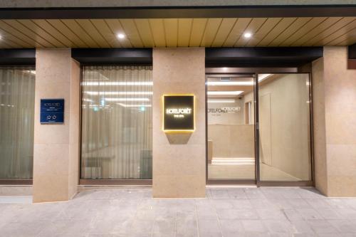 an elevator in a building with a sign on it at Hotel Foret The Spa in Busan