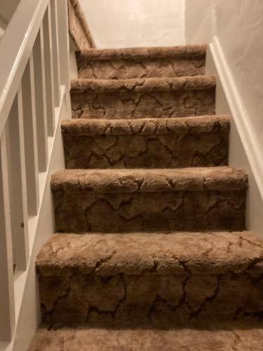 a set of stone stairs in a home at Quiet upstairs studio close to town 420 friendly in Trinidad