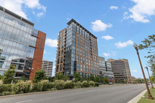 an empty street in a city with tall buildings at Placemakr Marymount Ballston in Arlington