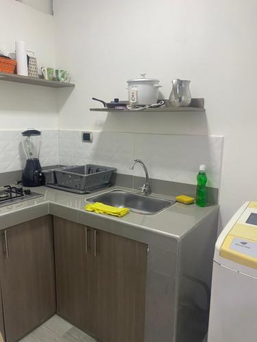 a kitchen with a sink and a counter top at APARTAESTUDIO Parque Olaya Pereira in Pereira