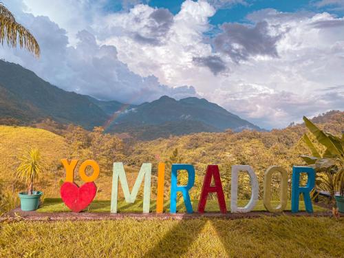 a sign that says yo marco in the grass at El Mirador de Tansu in Lanquín