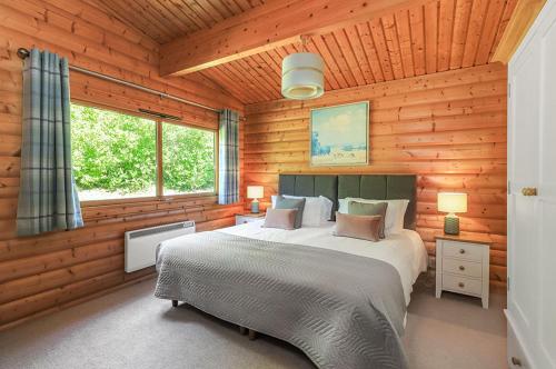 a bedroom with a large bed in a wooden room at South Winchester Lodges in Winchester