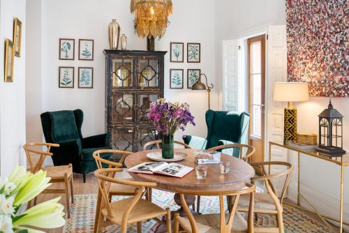 - une salle à manger avec une table et des chaises dans l'établissement Casa del Gobernador by Época Suites, à Séville