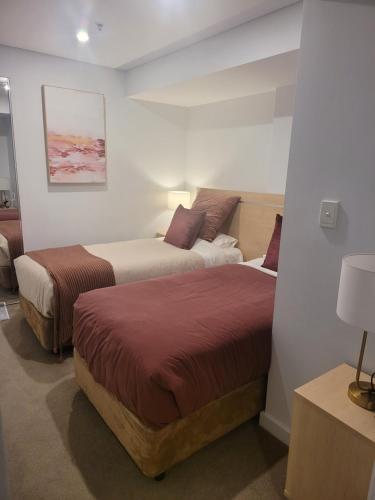 A bed or beds in a room at CBD Deluxe Private 2 Bedroom Apartment