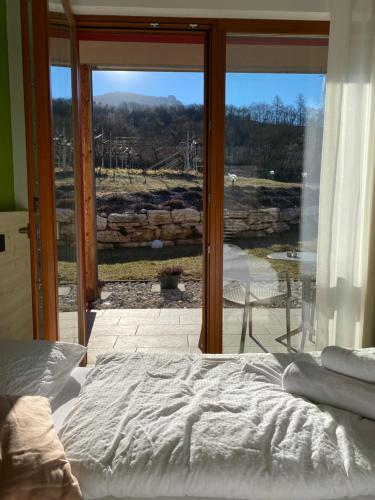 a bedroom with a bed in front of a window at Agritur Verderame in Trento