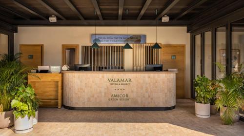 a lobby with a waiting area with potted plants at Valamar Amicor Resort in Stari Grad