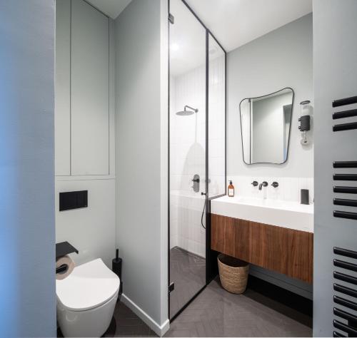 a bathroom with a toilet and a sink at Joro Living in Paris