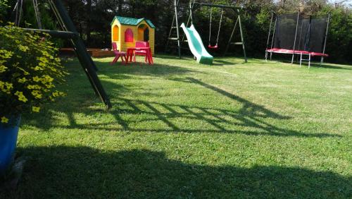 a group of playground equipment in a yard at Cztery Pory Roku - Domek 