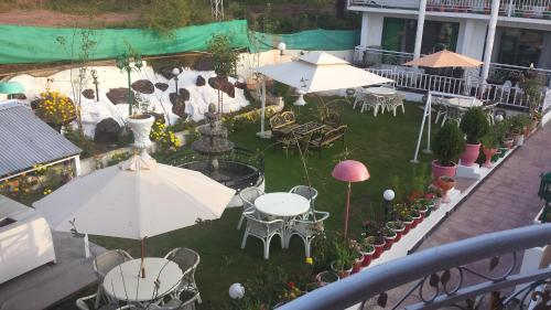 an overhead view of a patio with tables and umbrellas at European Complex in Bhurban