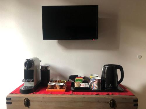 a table with a coffee maker on top of a table at Residenza Privata Pedrotti in Vicenza