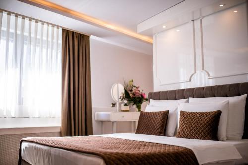 a bedroom with a large bed and a window at Amsterdam Hotel in Belgrade