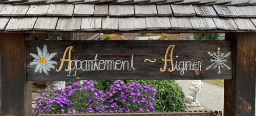 a sign for a garden with flowers in front of it at Appartement Aigner in Mauterndorf