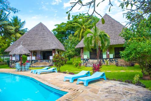 un complexe avec une piscine et une maison dans l'établissement Oasis Diani Beach Villas, à Diani Beach