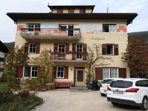 a building with cars parked in front of it at Molignon - Ortisei - Val Gardena in Ortisei