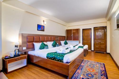 a bedroom with two beds and a rug at Muscatel BhumSang - 200 Mts from Mall Road in Darjeeling