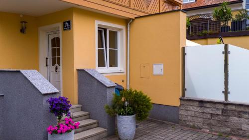 ein Haus mit zwei Topfpflanzen vor einer Tür in der Unterkunft Ferienwohnung Claudia in Salzburg