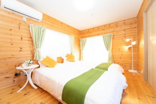 a bedroom with a white bed and a window at Yokkaichi Motomachi Hotel in Yokkaichi