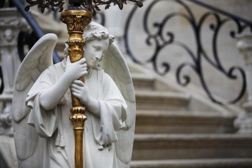 a statue of a little angel holding a pole at Sacred House in Urgup