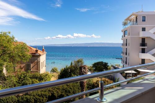 a view of the ocean from the balcony of a building at Marina Lux Split in Split