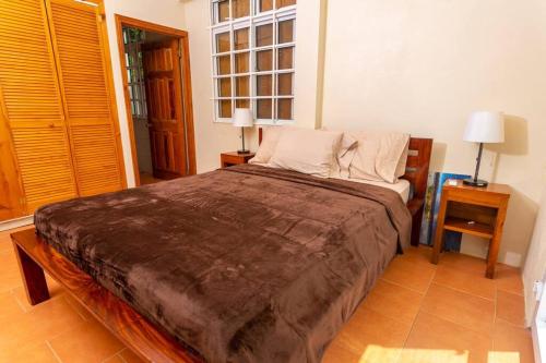 a bedroom with a large bed and a window at Oceanfront 3-bedroom villa with spectacular view! in Calibishie