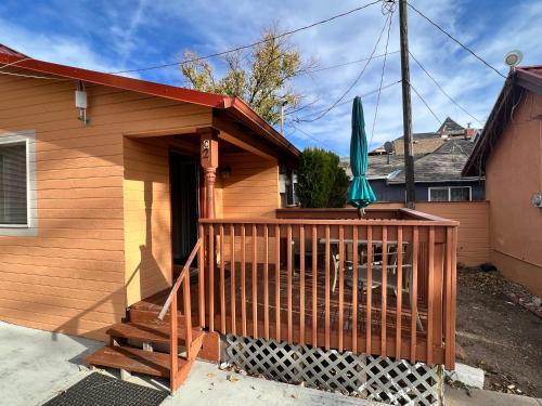 a house with a deck with a green umbrella at Garden of the Gods Motel in Colorado Springs