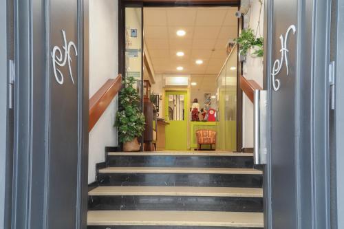 a hallway with stairs in a building at Hôtel Gloria in Grenoble