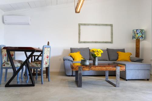 a living room with a couch and a table at Lavender farm house in Nafpaktos