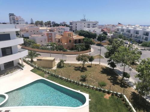 een luchtzicht op een gebouw en een zwembad bij Apartment 2 bedrooms , centre of Alvor, open view and private parking in Alvor