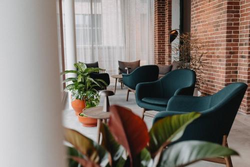 a row of chairs and plants in a room at Südspeicher in Kappeln