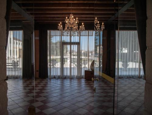 a large room with a chandelier and large windows at Residence Cà Beregana in Vicenza