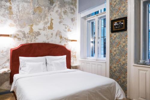 Postel nebo postele na pokoji v ubytování Metropolis Budapest Boutique Hotel