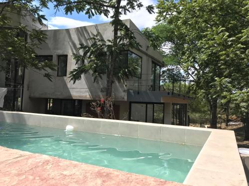 una casa con piscina di fronte a una casa di La Nube - San Lorenzo a San Lorenzo