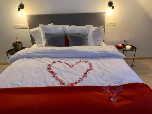 a bed with a heart written on it at Lovely 1-bedroom appartement Le Joyau with indoor pool and sauna in Lasne