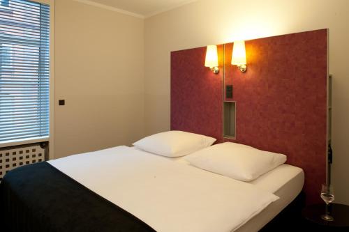 เตียงในห้องที่ Hotel Topas Frankfurt City