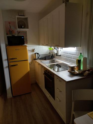 A kitchen or kitchenette at Apartman 7th Heaven