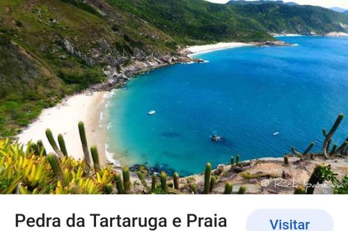 a view of a beach with cactus and the ocean at Pé nas trilhas in Rio de Janeiro