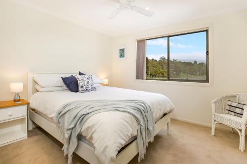 a white bedroom with a bed and a window at Villa Franco Pet Friendly 10 Mins Walk to Beach in Surf Beach