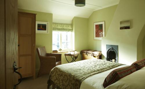 a hotel room with a bed and a fireplace at Hang Your Hat in Winchester