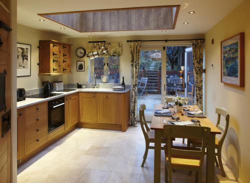 a kitchen with a table and a dining room at Hang Your Hat in Winchester