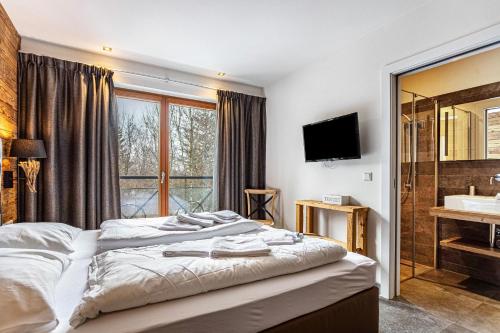 Schlafzimmer mit einem Bett, einem Waschbecken und einem Spiegel in der Unterkunft Mountain Lodge Leogang - Top4 in Leogang