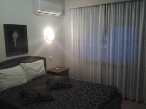 A bed or beds in a room at Residencial Pinto