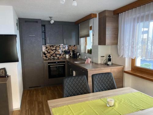 a kitchen with a table and chairs in a kitchen at Haus Castello in Saas-Almagell