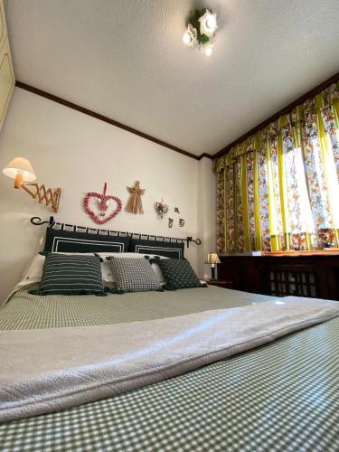 a bedroom with a large bed and colorful curtains at Skyline su Sestriere in Sestriere