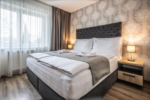 Cama ou camas em um quarto em Hotel Demanova Apartments - Dependance