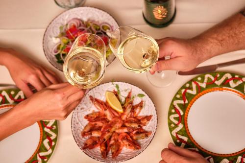 a group of people drinking wine at a table with food at Hotel Palma in Odesa