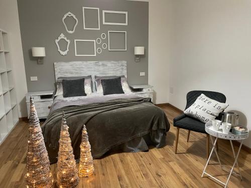 a bedroom with a large bed and a chair at Torremana in Càbras